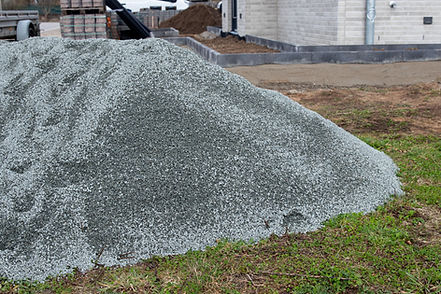 gray gravel on grassy ground near construction site