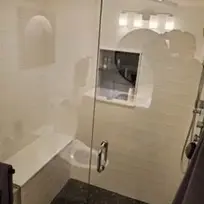 Renovated shower with black floor