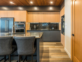 Modern kitchen with stainless steel appliances, cabinetry, and a dark island.
