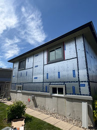 Home exterior with installed silver rigid foam insulation