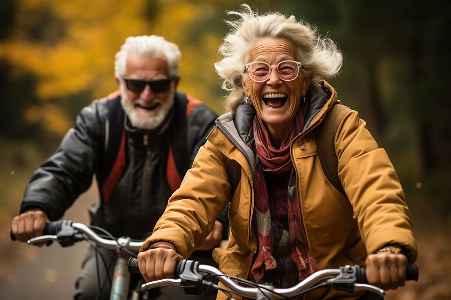 Cheerful active senior couple with bicycle in public park together having fun lifestyle. P