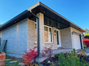 Modern brick bungalow with black soffit and fascia
