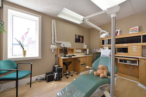Dental exam room with patient chair and teddy bear