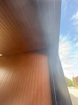 Modern wood paneling on a gallery ceiling and wall