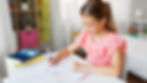 Girl studying for 11+ verbal reasoning test at home.