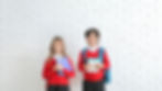 Two children in school uniform with books ready to prepare for their Verbal Reasoing exam.