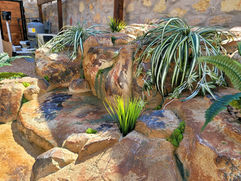 Close-up of a faux rock waterfall, focusing on lifelike textures and meticulous design.