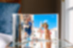 SimplePrints photo books of a vacation on top of a glass table. 