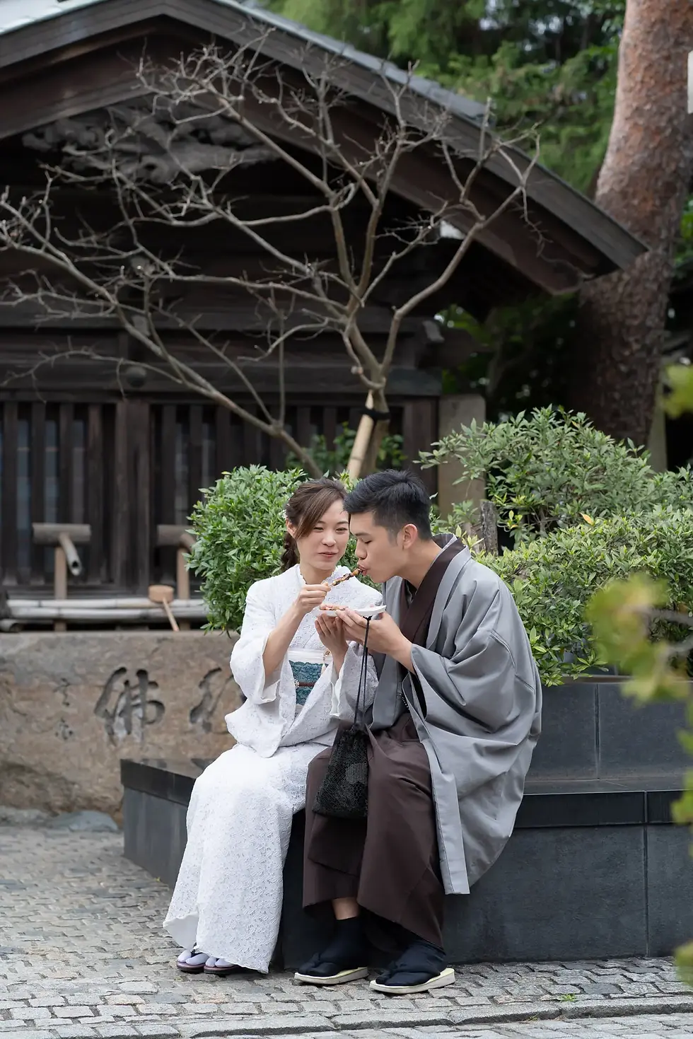 Two people in colorful kimonos having fun exploring the local streets of Kawagoe.