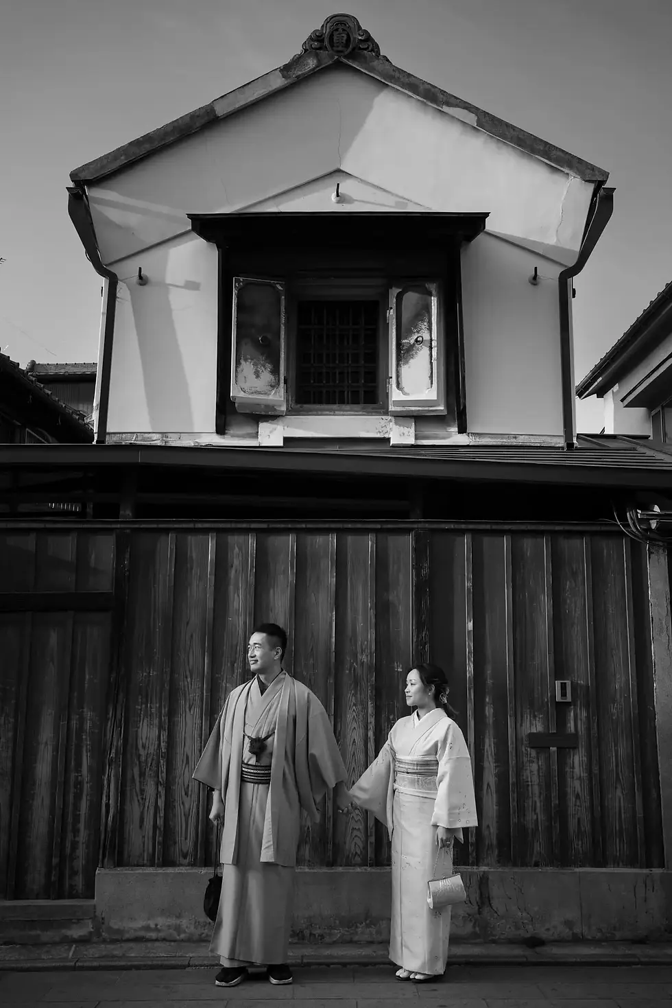 A smiling couple in kimonos enjoying street food in Little Edo, Kawagoe.