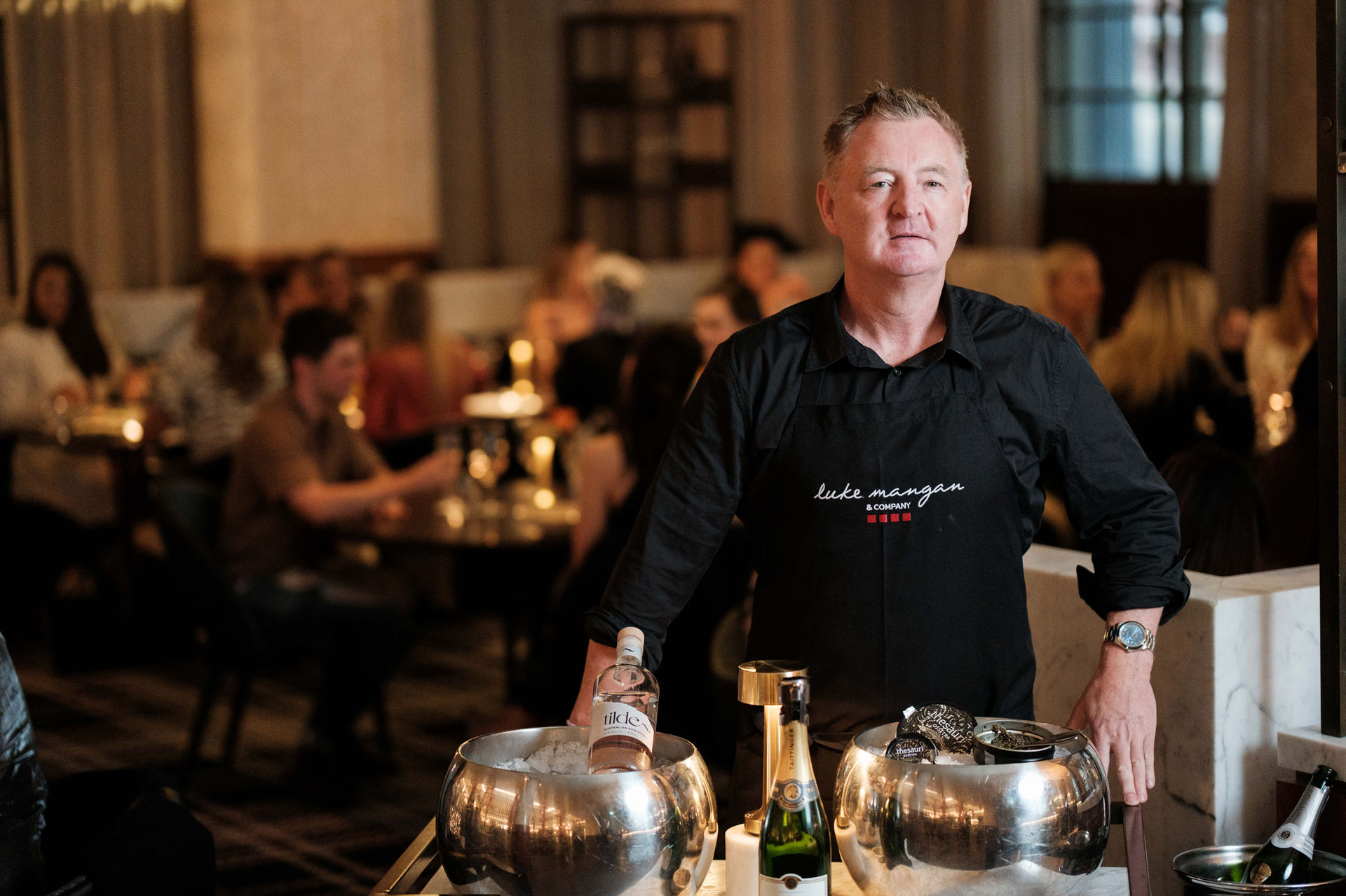 Chef Luke Mangan presenting his caviar trolley at Luke’s Kitchen restaurant, photographed by Oscar Colman.