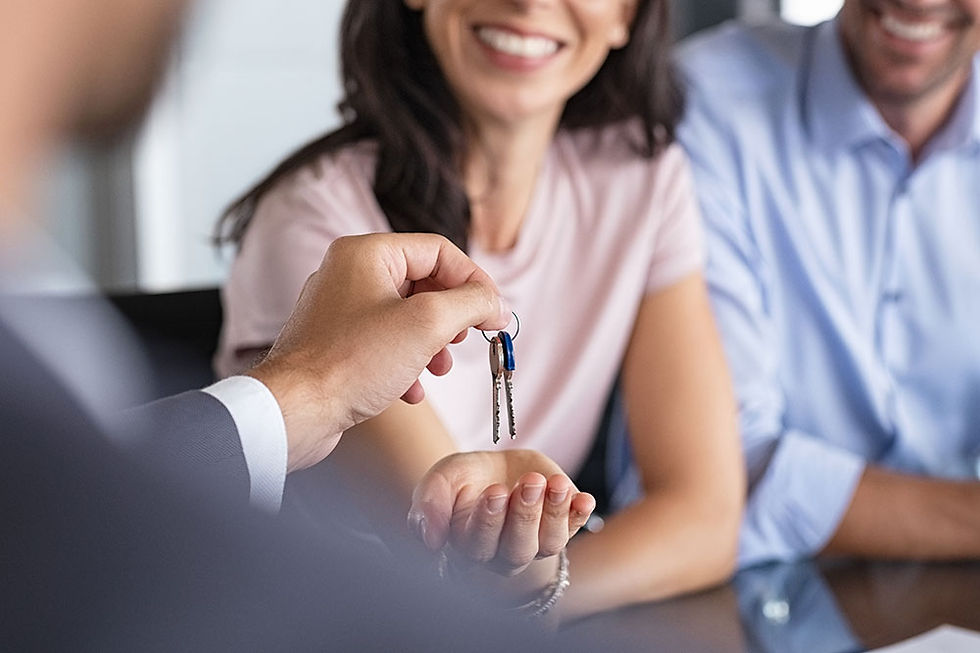 A young couple getting the keys to their brand new house