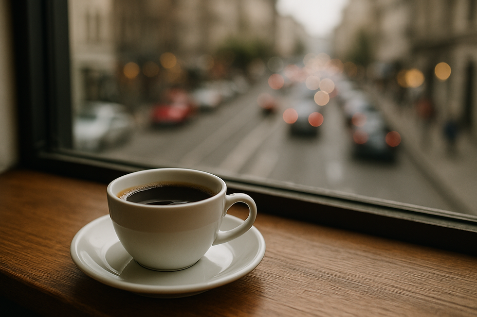 A coffee cup on a wooden windowsill with a blurred city street outside. Warm tones create a calm, cozy atmosphere. No visible text.