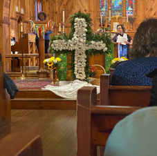 Karen singing during flowering service.jpeg