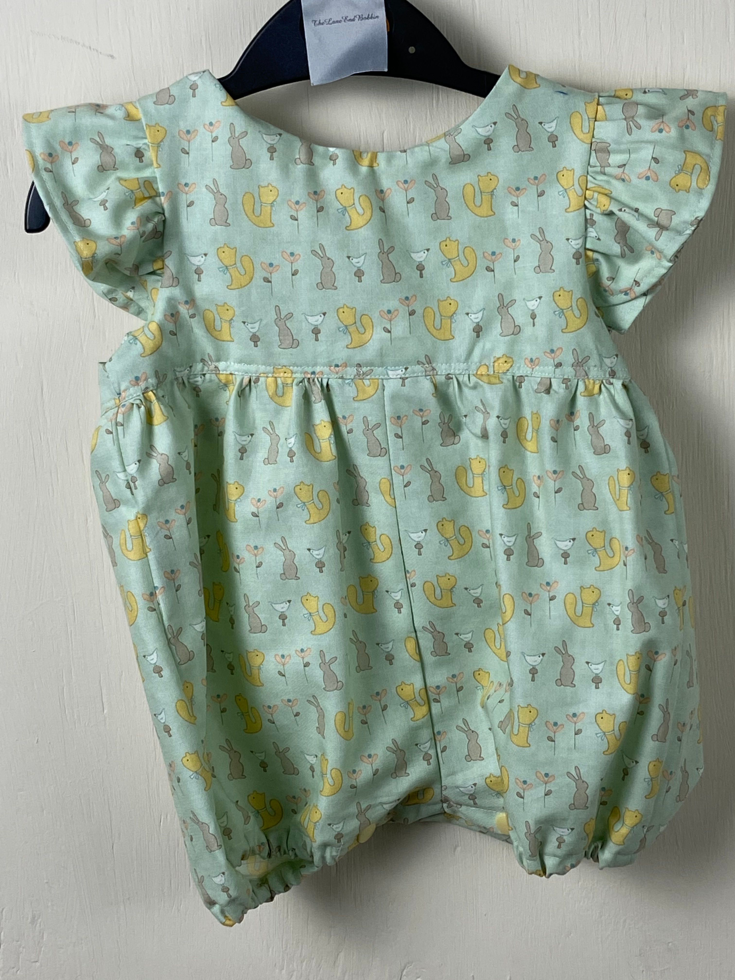 Millie - light green patterned short legged romper suit - 12 -18 months