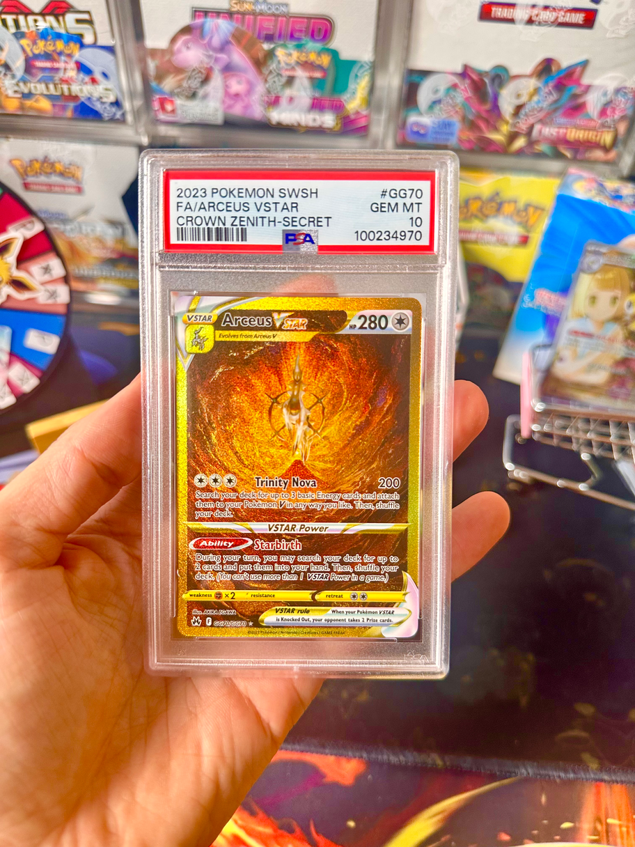 A person holds a card in front of a table, showcasing the card's design and details to the viewer.