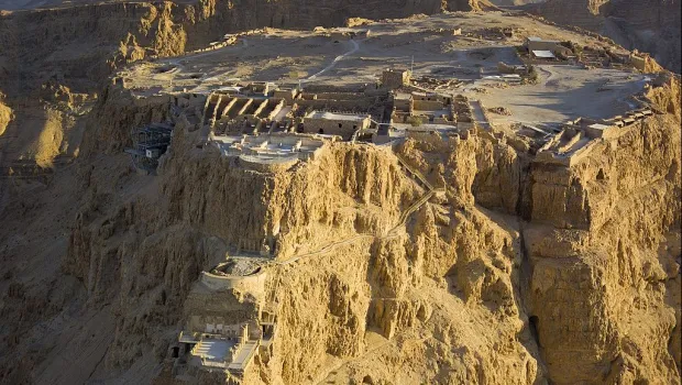 Aerial view of Masada National Park, highlighting the dramatic cliffside fortress rising above the Dead Sea region.