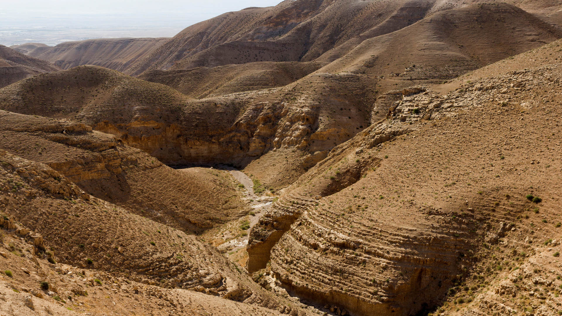 Deep desert canyon and hiking trail winding through the arid mountains of Israel.