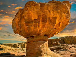 The iconic red sandstone Mushroom rock formation in Timna Park at sunset, showing unique desert erosion in the Arava Valley.