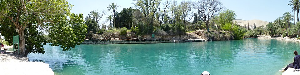 Wide panoramic landscape view of the sweeping clear spring pools, shaded banks, and natural forest surroundings at Sachne Israel.