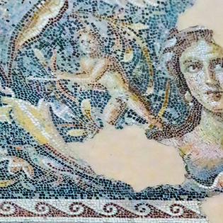 Close-up of the "Mona Lisa of the Galilee," a world-famous 3rd-century Roman mosaic tile floor depicting a beautiful woman at Zippori National Park.