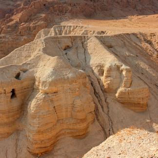 The limestone cliffs of the Judean Desert featuring the openings of the Qumran caves.