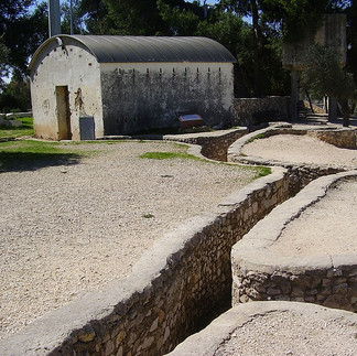 Tourists walking through the narrow historical trenches at Ammunition Hill during a guided Jerusalem tour.