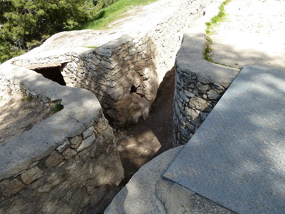 Historical stone trenches leading to a fortified military bunker at the Six-Day War battle site.