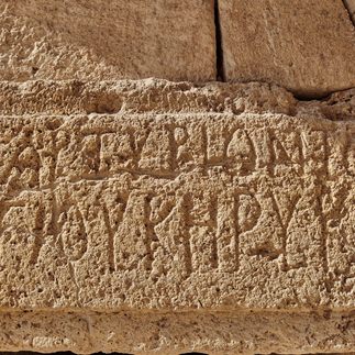 Ancient Greek inscription on a stone block. A detailed archaeological artifact found in Jerusalem, showcasing the Greco-Roman influences on the city's long history.