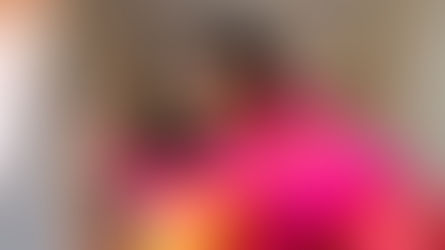 !Eye-level view of a woman draping a bright silk saree in a traditional style