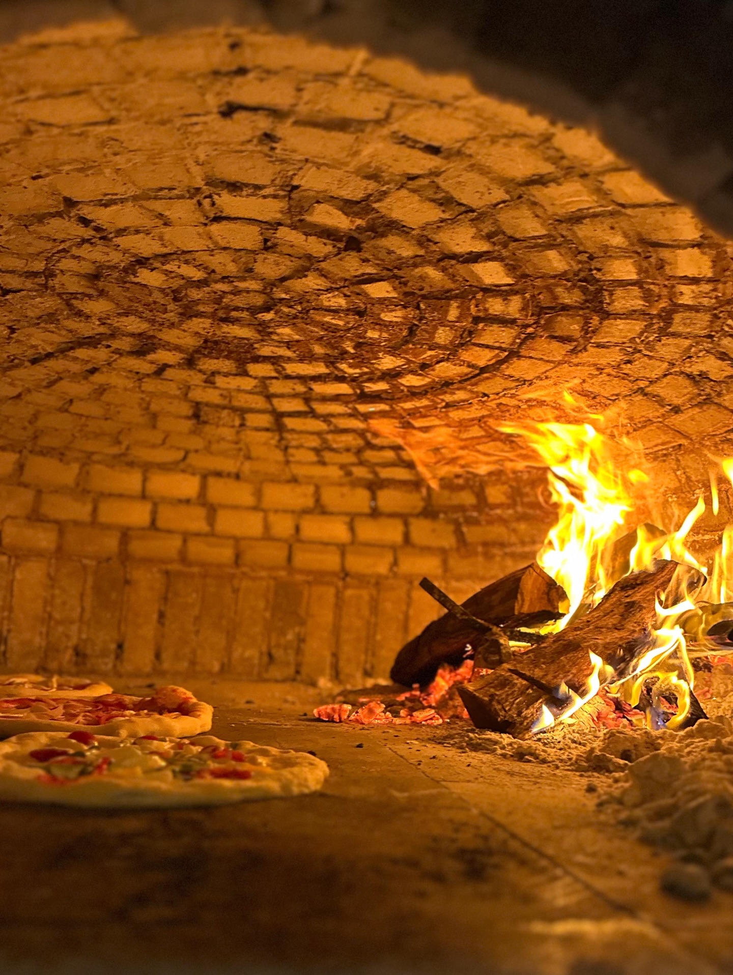 Wood-fired pizza oven at Bocanerra Pizzeria, Aldea Zama