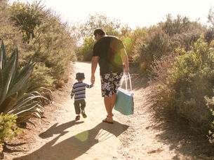 A father and son walking on a trail