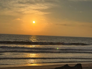 Sunset on the beach as waves come in