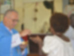 Parishioner receiving communion from His Lordship Bishop Dariusz Kaluza MSF