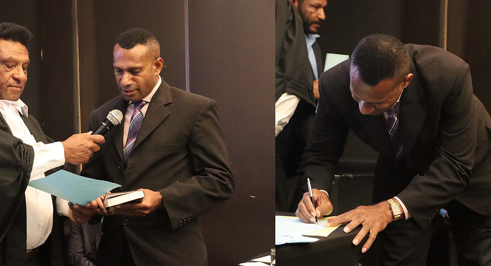Mr Vincent Sobo reciting the oath and signing the official document during the swearing-in ceremony today.