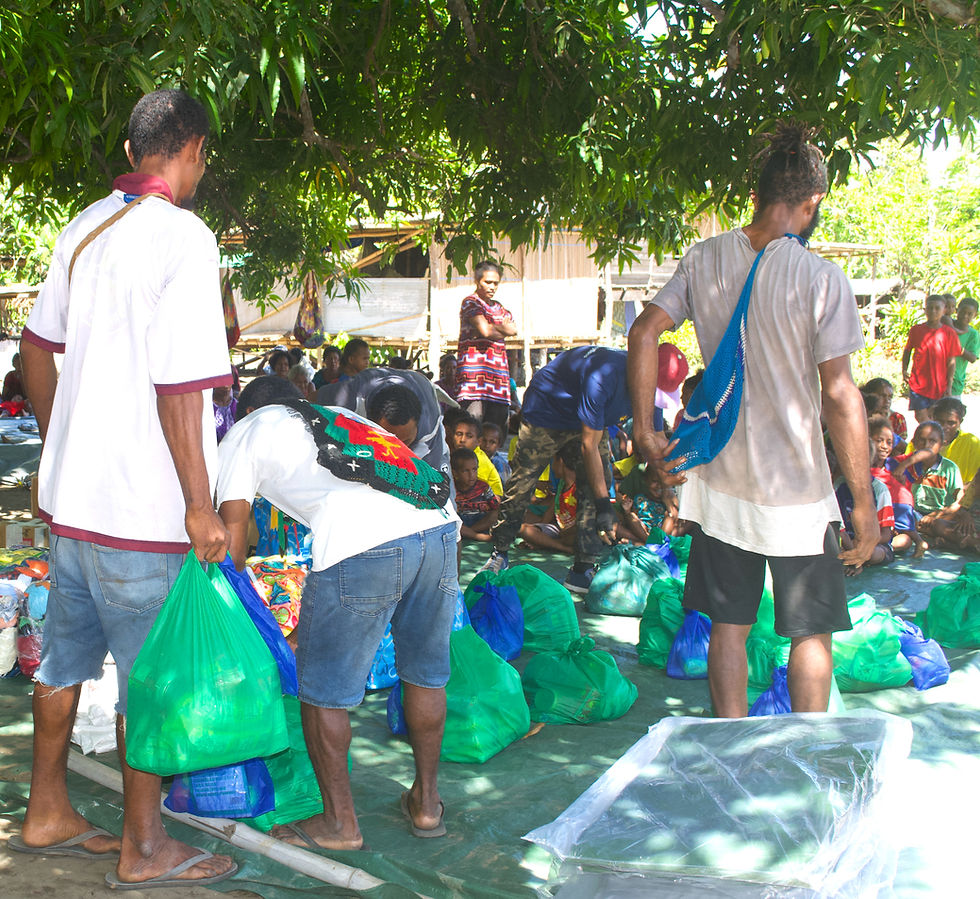 (Village volunteers assisting the CBC team to sort out the donation items)