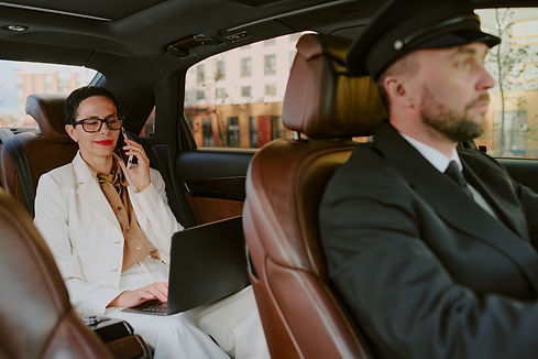 chauffeur driving luxury vehicle in city.jpg
