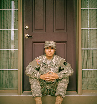 woman sitting in front of closed door_ed