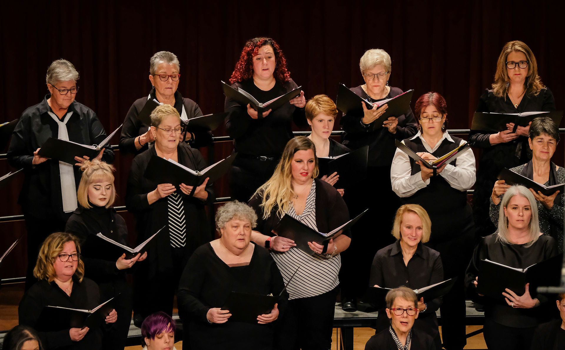 The VOICES choir performs on stage