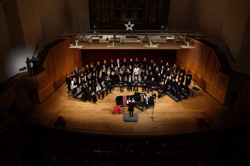 The VOICES choir performs on stage