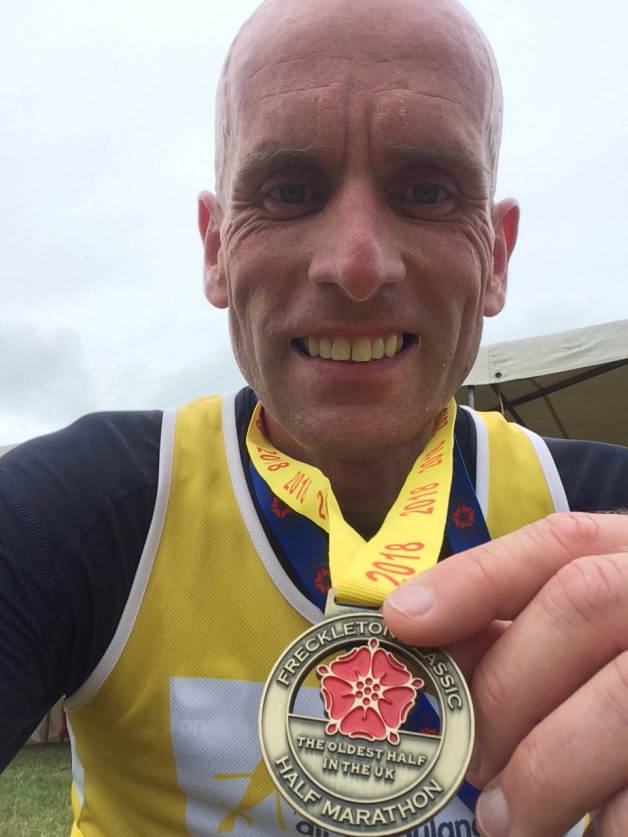 man posing with medal
