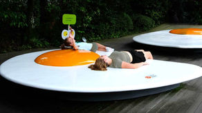 Kids lying on giant fried egg sculptures in Hakone Open Air Museum, Japan