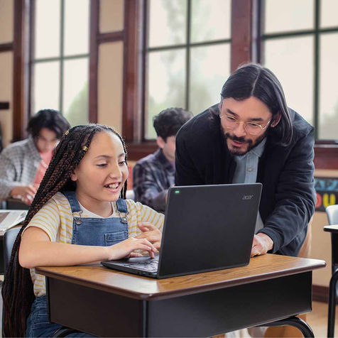 A smiling student and teacher collaborate in a modern classroom, captured as part of Microsoft Education’s TikTok campaign for K–12 digital learning and engagement.
