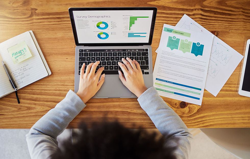 researching target audience, laptop with statistic sheets of papers
