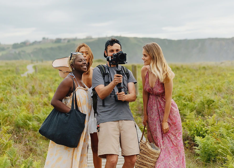 filmmaker surrounded with friends, outdoor shooting, people smiling