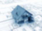 3D model of custom home on top of architectural blueprints, illustrating residential construction planning and design.