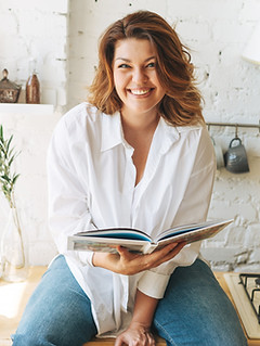 Gorgeous happy young woman plus size body positive in blue jeans and white shirt reading c
