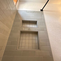 Finished tiled recessed shower niches with Schluter trim