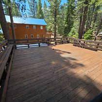 Existing deck top with weathered redwood and original baluster railing