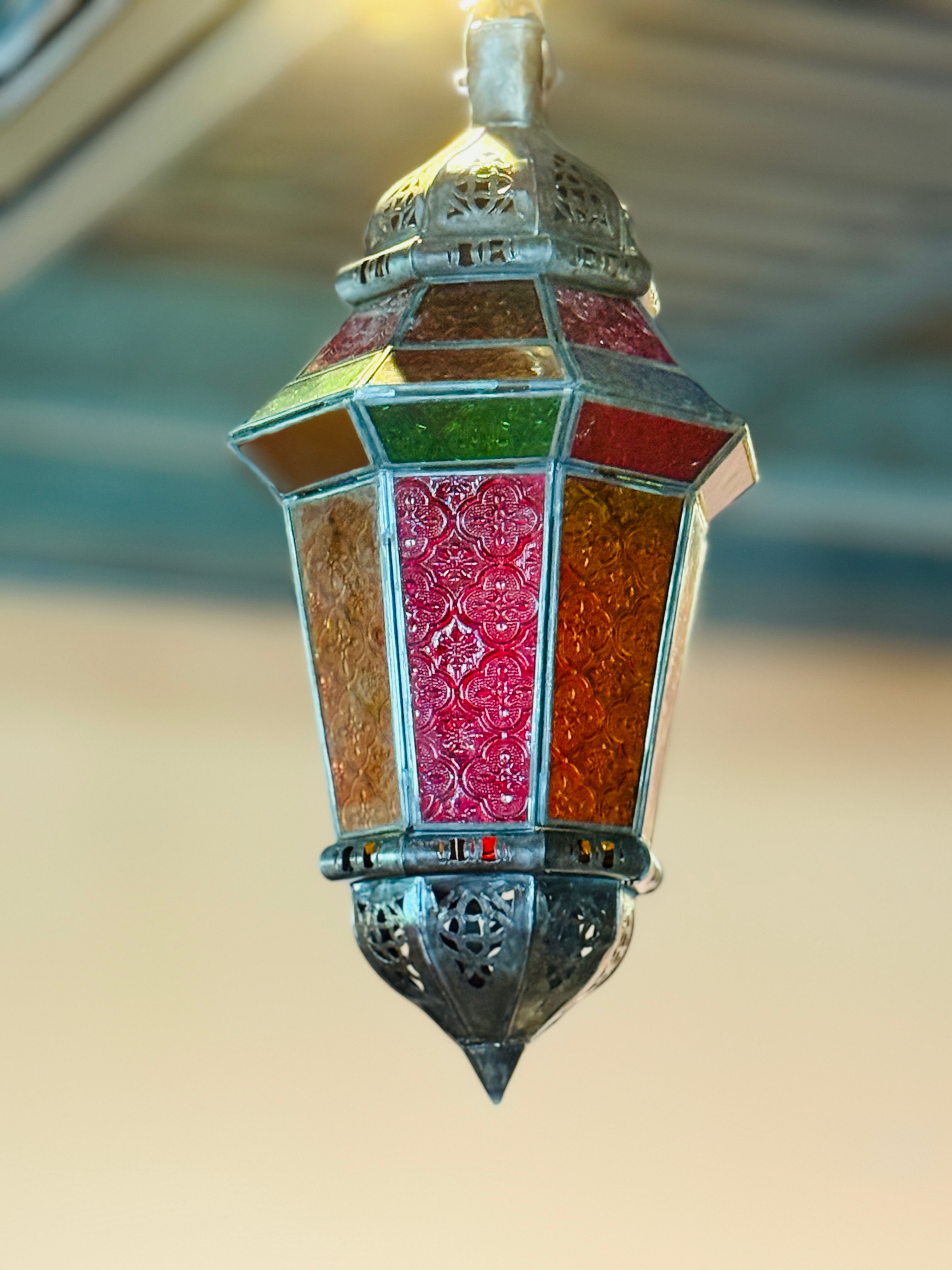 Ornate Moroccan-style hanging lantern with an antique silver or pewter finish